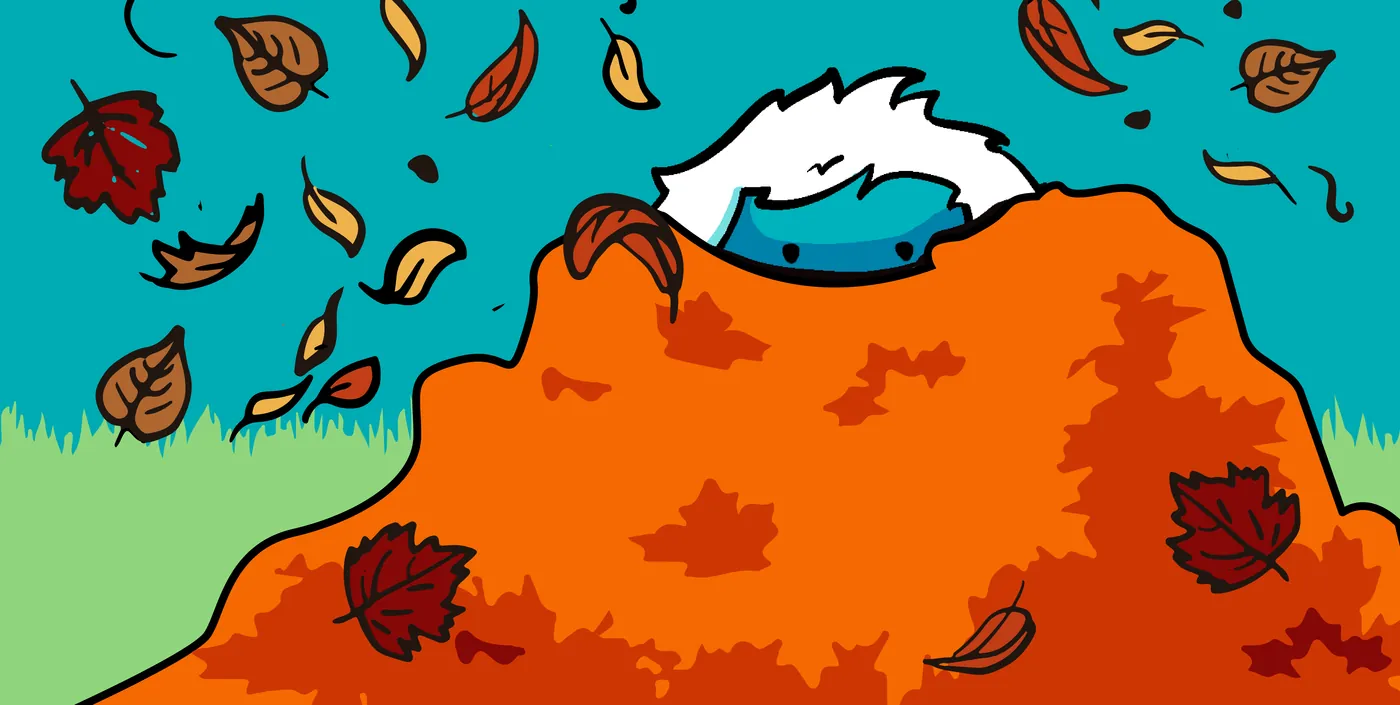 The Northern Snow yeti peeking out of a big pile of fall leaves